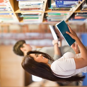 Students reading while standing up in a library-1